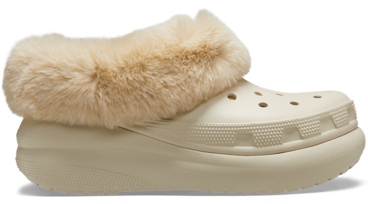 Bone-colored Crocs Furever Crush Clog featuring a plush faux fur collar, classic ventilation holes, and a chunky platform sole for added comfort.