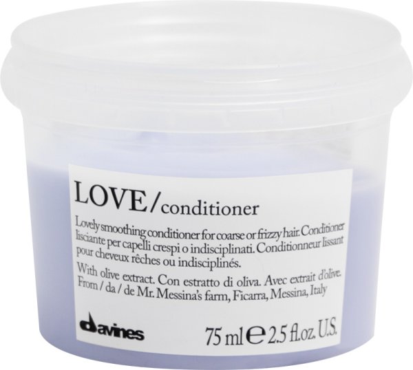 Lavender-hued smoothing conditioner in a clear plastic jar with a white label, featuring black text and a logo, designed for coarse or frizzy hair.