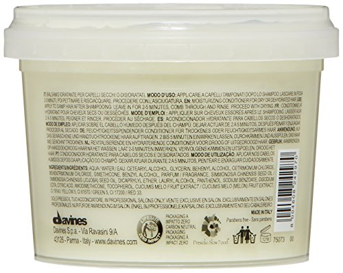 White plastic container of Davines MOMO Moisturizing Conditioner, 2.5 oz, featuring a cream-colored lid and detailed product information on the back in black text.