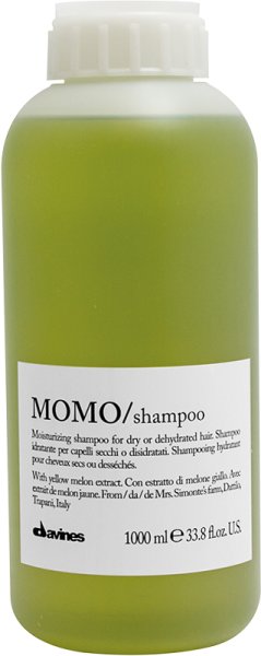 Green plastic bottle of Davines Momo Moisturizing Shampoo, 33.8 oz, featuring a white label with black text, highlighting its hydrating properties and key ingredients.