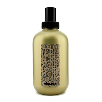 Gold spray bottle with a black nozzle, featuring a decorative label with colorful patterns and text, labeled "Davines MORE INSIDE THIS IS a SEA SALT SPRAY 8.45 OZ for UNISEX."
