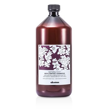 Dark amber plastic bottle of Davines Replumping Shampoo, featuring a white floral design and a black cap, labeled with product details in a white block.