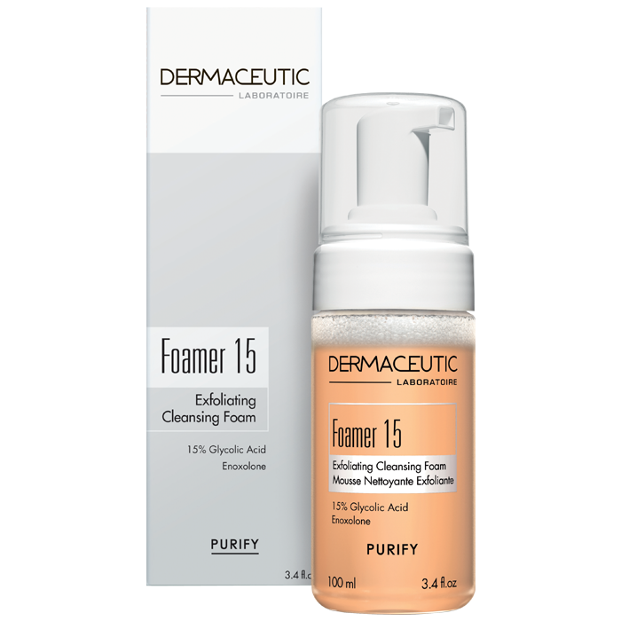 White pump bottle with a transparent base, labeled "Foamer 15" in bold letters, featuring a light orange exfoliating cleansing foam, highlighting 15% glycolic acid.