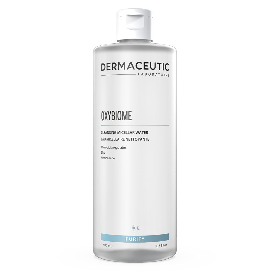 Clear plastic bottle of Dermaceutic Oxybiome Cleansing Micellar Water, 400 ml, featuring a minimalist design with a white label and blue accents, labeled "PURIFY."