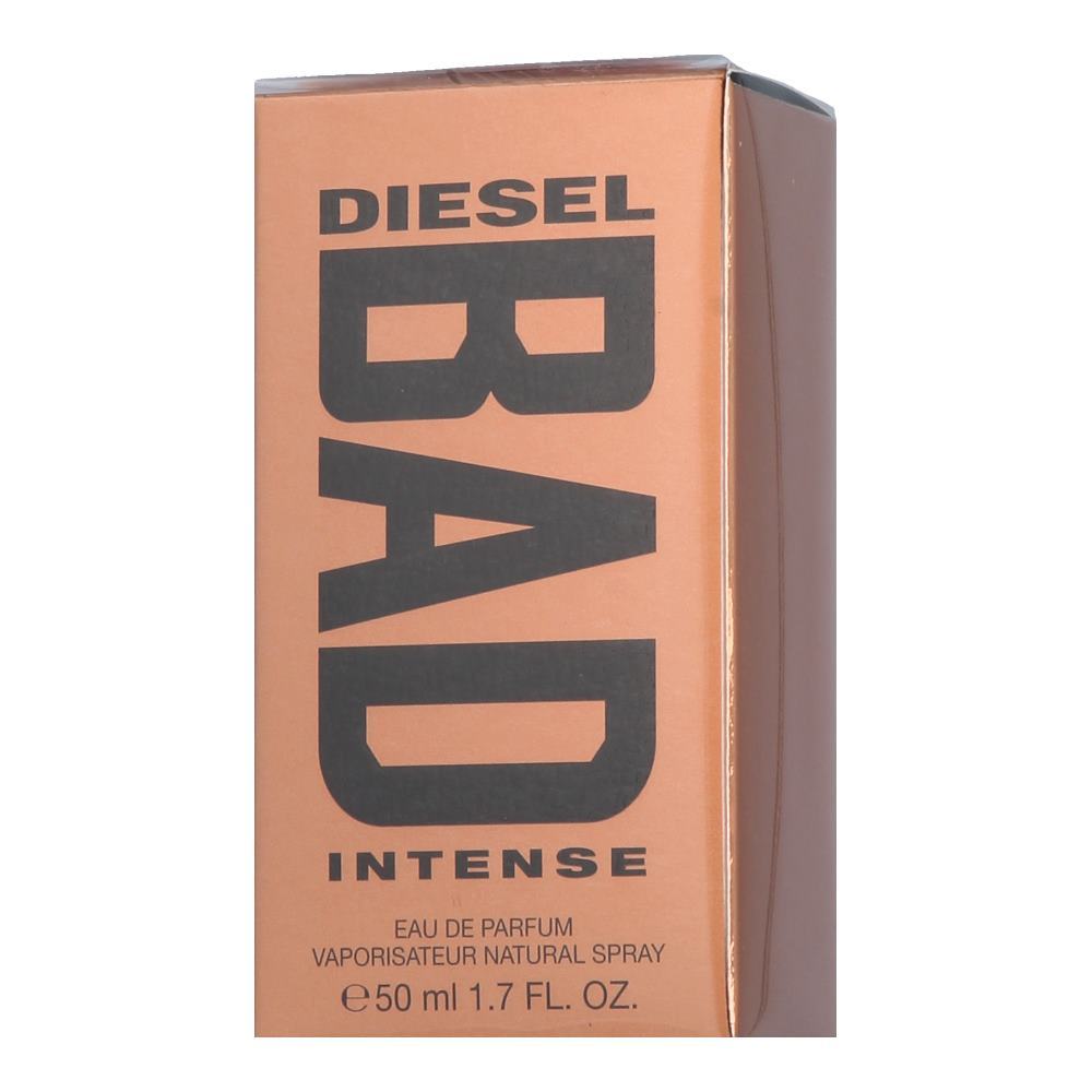 Bronze box featuring bold black text reading "DIESEL BAD INTENSE," with details about the fragrance and size, designed for men's eau de parfum, 1.7 oz.