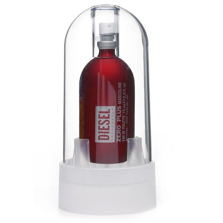 Red glass bottle of Diesel's ZERO PLUS Eau De Toilette Spray, 2.5 oz, encased in a clear dome with a white base, featuring bold white text on the bottle.