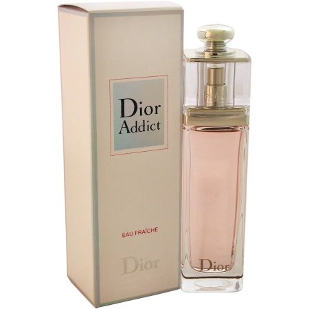 Clear glass bottle with a gold cap, containing light pink fragrance, alongside a beige box featuring the "Dior Addict" label in elegant font.