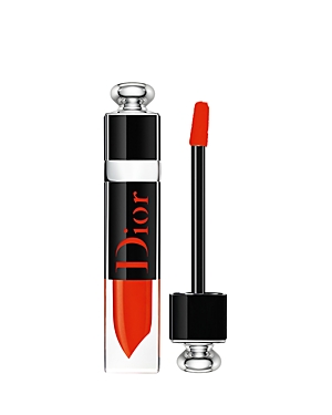 Christian Dior Addict Lacquer Plump in shade 648 Dior Pulse, featuring a sleek transparent tube with a silver cap and a red applicator wand, showcasing a vibrant red liquid lipstick.