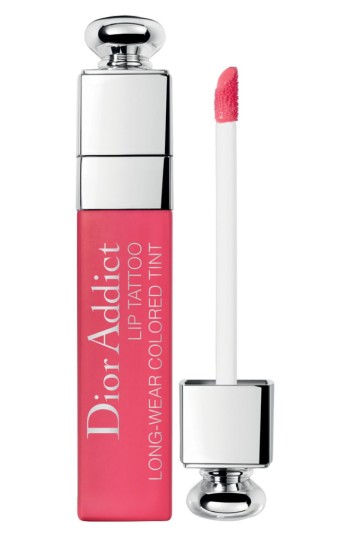 Dior Addict Lip Tattoo in a vibrant pink shade, featuring a sleek, clear tube with a silver cap and a white applicator wand.