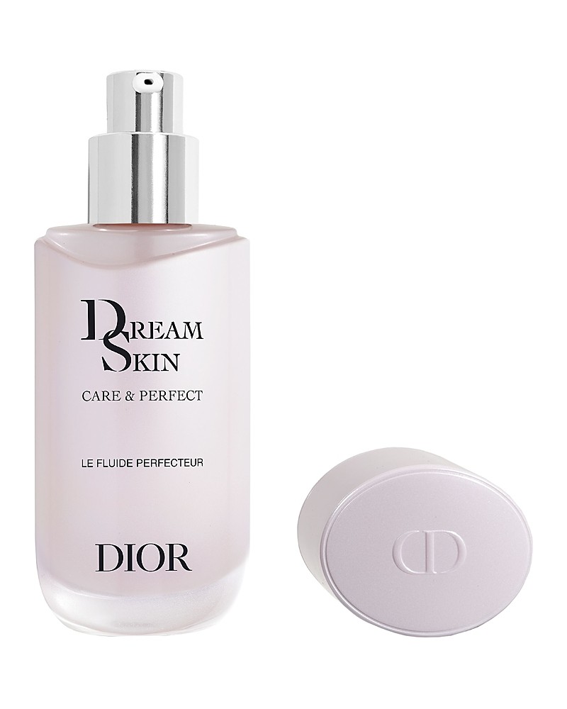 A frosted glass bottle with a silver pump, labeled "Dreamskin Care & Perfect" by DIOR, accompanied by a lavender cap, showcasing a sleek and elegant design.