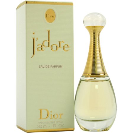 Clear glass bottle with a gold-accented neck, featuring a round cap, beside a light green box with gold text reading "J'adore Eau De Parfum" and "Dior."