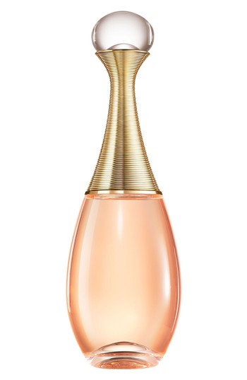 Elegant glass bottle with a curved shape, featuring a gold ribbed neck and a round clear cap, filled with light pink Eau De Toilette, labeled "Christian Dior J'adore Injoy."