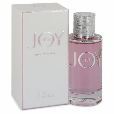 Clear glass bottle with a silver cap and pink liquid, accompanied by a white box featuring the word "JOY" in silver lettering.