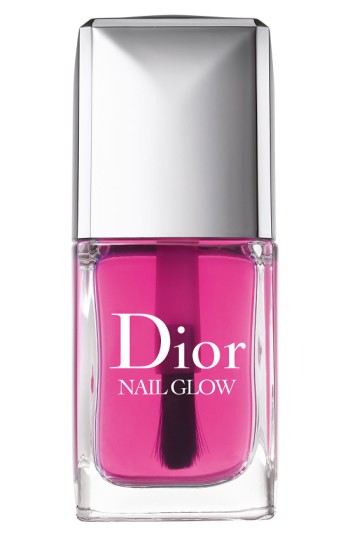 Dior Nail Glow in a clear glass bottle with a sleek silver cap, featuring a vibrant pink polish and a wide brush for easy application.