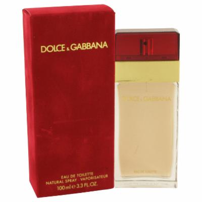 Clear glass bottle with a gold and red cap, featuring a gold band, alongside a red box with gold lettering, labeled "Dolce & Gabbana Eau De Toilette Spray 3.3 Oz."