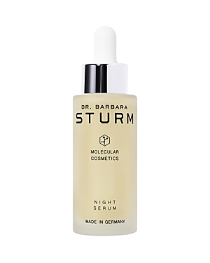 Clear glass bottle with a white dropper cap, featuring black text that reads "Dr. Barbara Sturm MOLECULAR COSMETICS NIGHT SERUM," made in Germany.