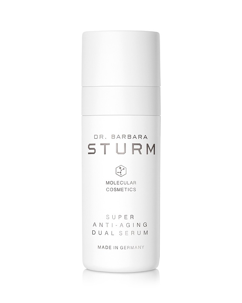 White cylindrical bottle with a sleek design, featuring the text "Dr. Barbara Sturm" and "Super Anti-Aging Dual Serum" in elegant black font, labeled as "Made in Germany."