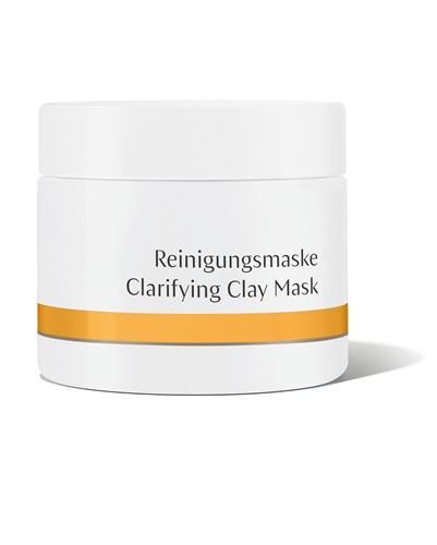 White jar with a smooth finish, featuring a gold band and black text reading "Clarifying Clay Mask" and "Reinigungsmaske," indicating a 90 g skincare product.