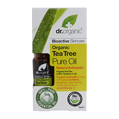 Dark brown glass bottle of Dr Organic Tea Tree Pure Oil, with a green and white box featuring the brand logo, highlighting "100% Pure Essential Oil" and "Natural Antiseptic."