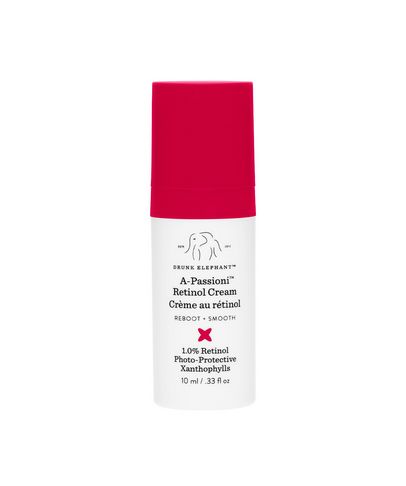 White cylindrical bottle with a bright pink pump lid, labeled "A-Passioni Retinol Cream," featuring details about retinol concentration and benefits for women.