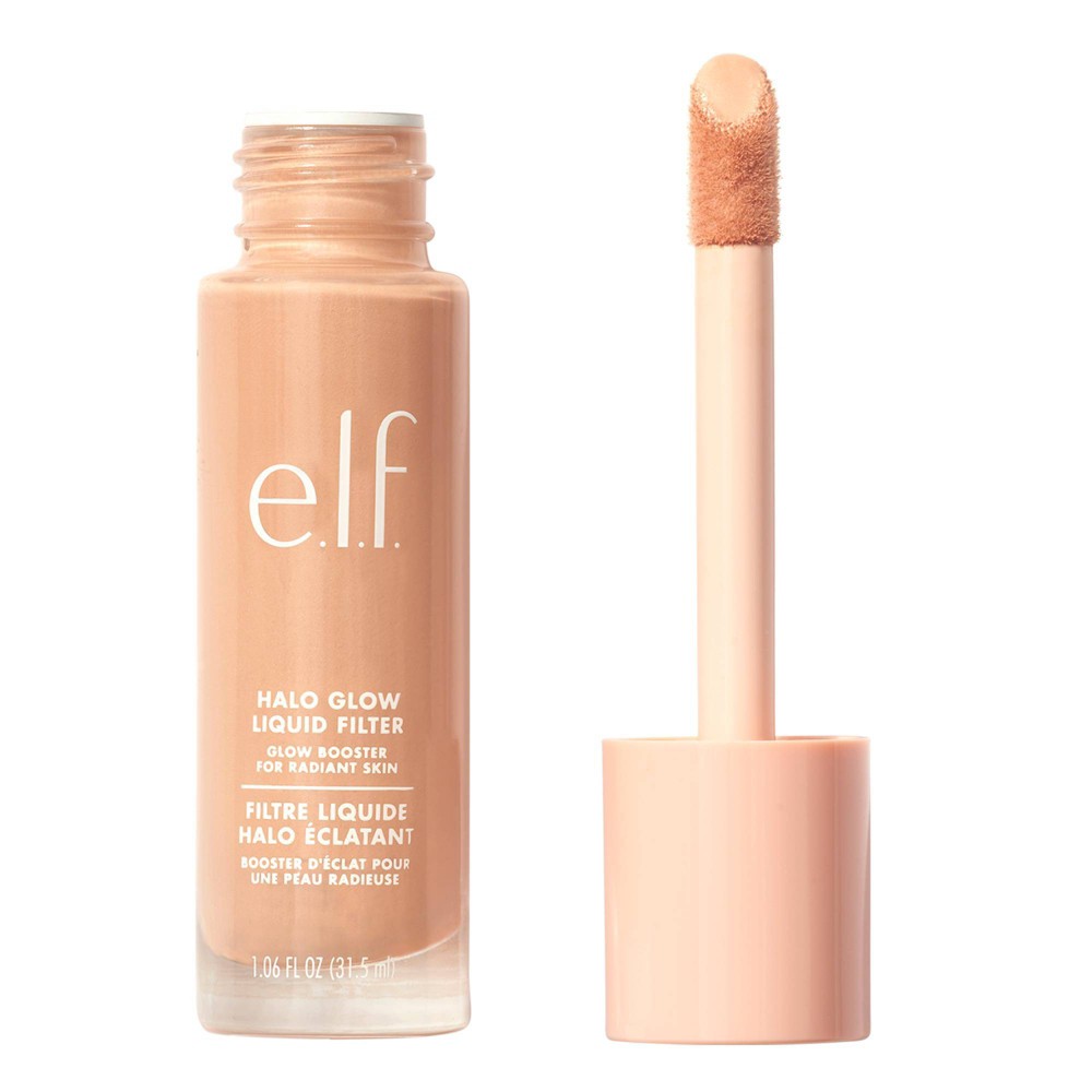E.l.f. Halo Glow Liquid Filter Highlighter in a light/medium shade, housed in a clear glass bottle with a pink cap and a doe-foot applicator for easy application.
