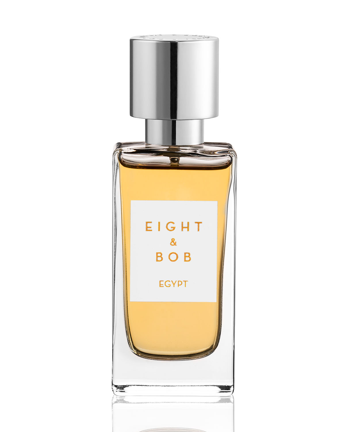 Clear glass bottle with a rectangular shape, featuring a silver cap and a white label that reads "EIGHT & BOB EGYPT," containing a golden-yellow Eau De Parfum.
