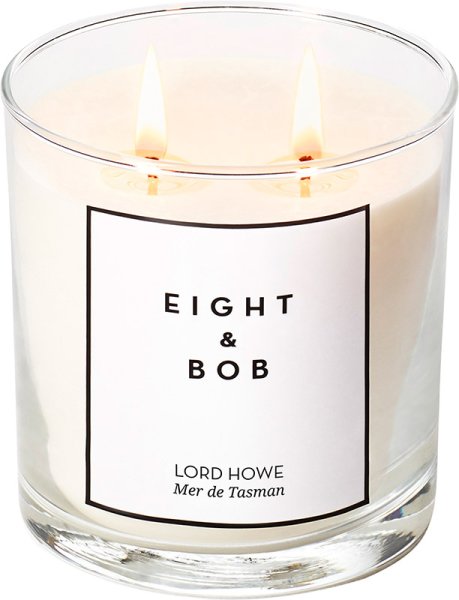 A clear glass candle featuring two wicks, filled with creamy white wax, labeled "EIGHT & BOB LORD HOWE Mer de Tasman" in elegant black text.