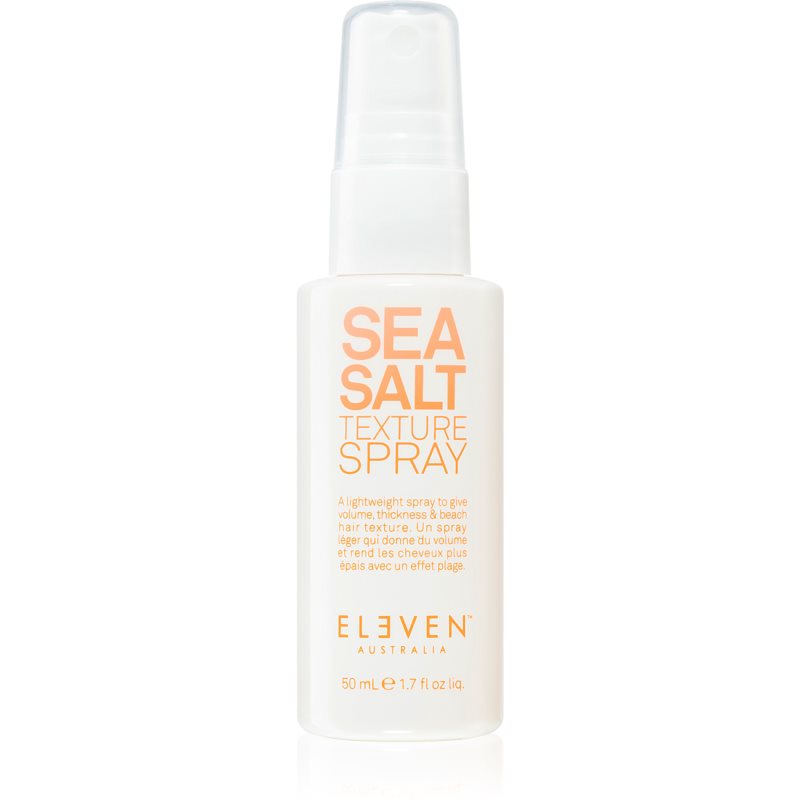 Clear plastic spray bottle with a white pump top, labeled "SEA SALT TEXTURE SPRAY" in orange text, containing 50ml of a lightweight hair product by Eleven Australia.