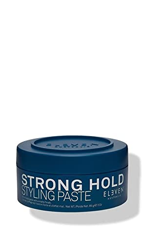 Blue round container of Eleven Australia Styling Paste, labeled "STRONG HOLD" in white text, with a matte finish, containing 3 ounces (85g) of product.