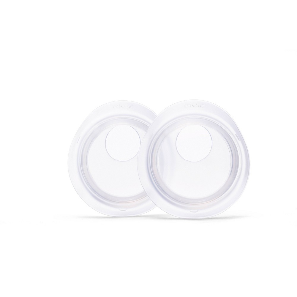 Two transparent, circular milk collection cups made of durable plastic, featuring a central opening for secure attachment, designed for breastfeeding convenience.