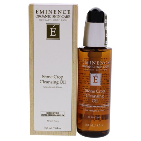 Amber glass bottle with a black pump cap, labeled "Stone Crop Cleansing Oil" in elegant font, accompanied by a light brown cardboard box featuring the brand logo and product details.