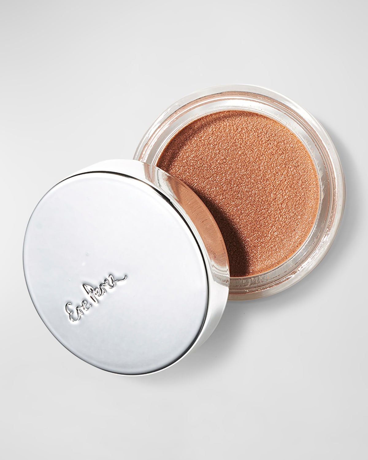 Cacao Bronzing Pot by Ere Perez, featuring a shiny silver lid with embossed logo, revealing a creamy, warm bronze product inside.
