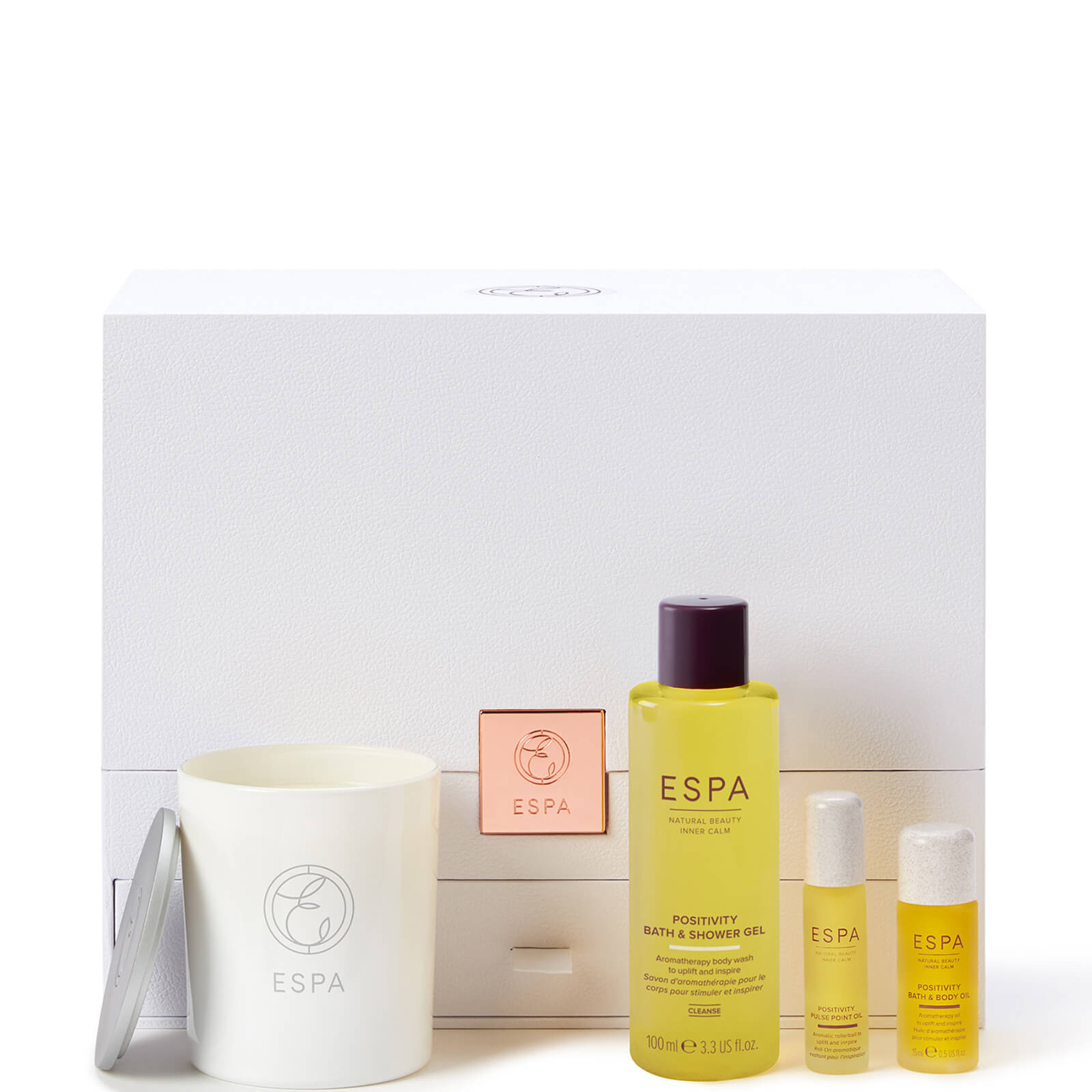 White gift box containing a yellow shower gel, two small yellow oil bottles, and a white candle, all labeled with the ESPA logo.