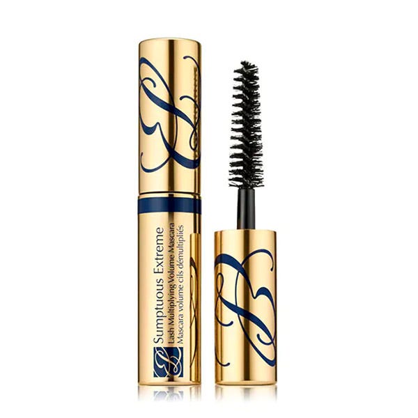Travel-size black mascara in a gold and navy tube with elegant lettering, featuring a bristle brush for volumizing lashes.