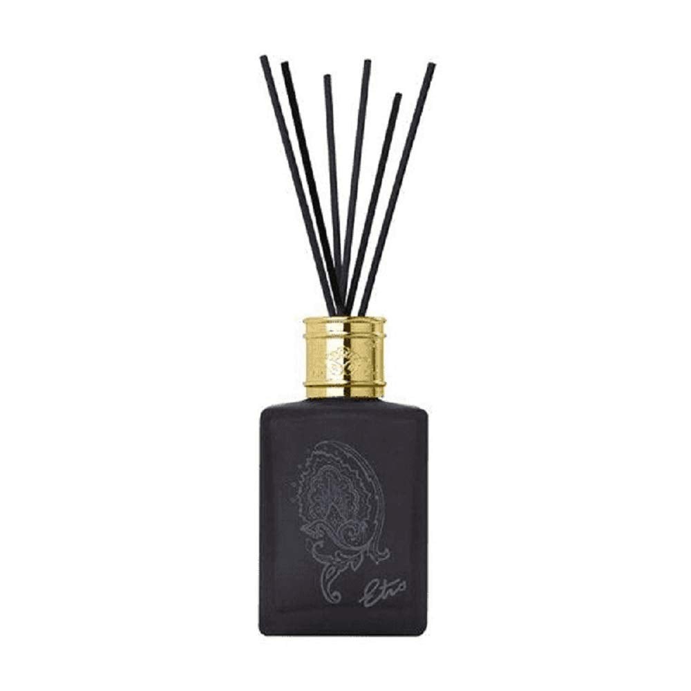 Black glass diffuser bottle with a gold cap, featuring a paisley design, accompanied by several black reed sticks for fragrance dispersal.