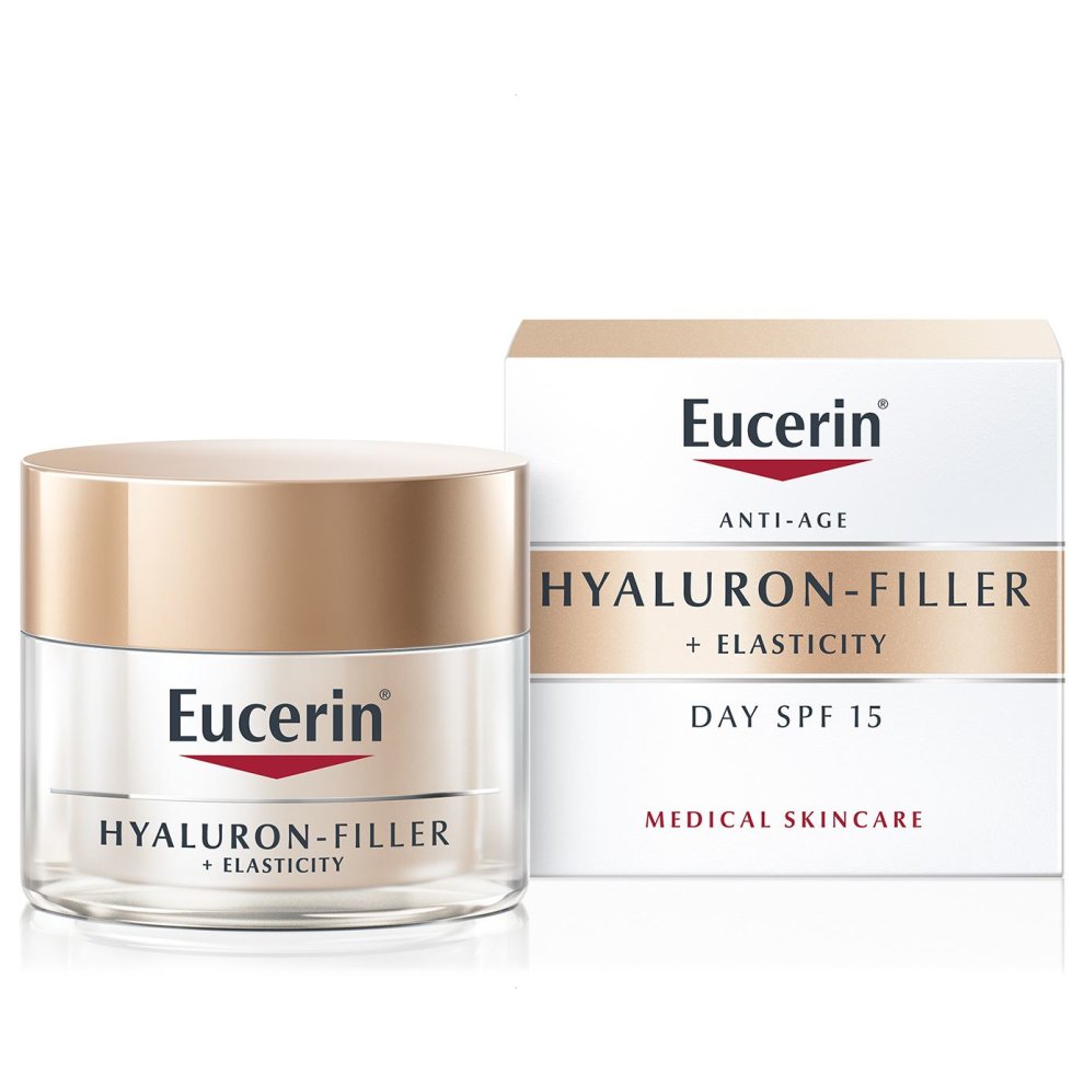 Eucerin Hyaluron-Filler + Elasticity Day Cream in a clear jar with a gold lid, accompanied by a white box featuring gold and red text, labeled as anti-age with SPF 15.