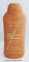 Cocoa butter hand and body lotion in a 500ml amber-colored bottle with a curved design, featuring gold accents and a flip-top cap, labeled "Ever Sheen."