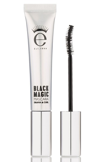 Black tube with silver accents featuring "BLACK MAGIC" text, accompanied by a black mascara wand with a curved brush for drama and curl.