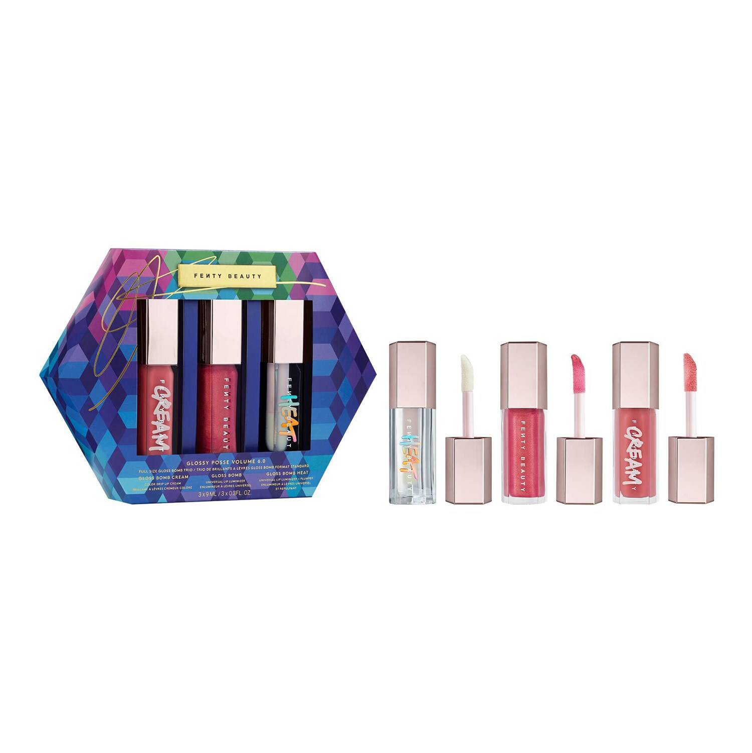 Three lip glosses in sleek, transparent tubes with metallic caps, featuring shades of pink and clear, presented in a colorful hexagonal box with geometric patterns.