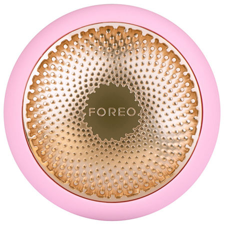 Round device in pearl pink with a gold textured surface, featuring a central "FOREO" logo and small silicone nodules for facial treatment.