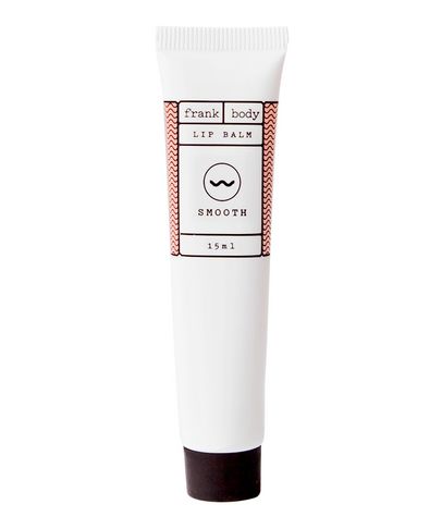 White tube of Frank Body Lip Balm Original, 15ml, featuring a minimalist design with a red zigzag pattern and the word "SMOOTH" prominently displayed.