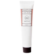 White tube of Frank Body Lip Balm (15ml) with a brown and white label featuring a wavy line and simple text, capped with a dark brown twist-off lid.