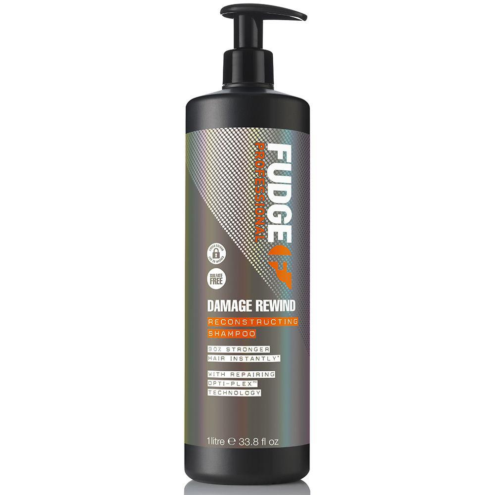 Black plastic bottle with a pump, featuring a vibrant label in orange and silver, labeled "Fudge Professional Damage Rewind Repairing & Reconstructing Shampoo," 1000ml.