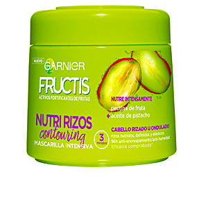 Bright green plastic jar labeled "Garnier Fructis Hydra Mask Curls 300ml," featuring a colorful design with pistachio illustrations and text highlighting intense nourishment for curly hair.