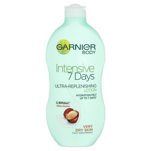 Light green plastic bottle of Garnier Intensive 7 Days Shea Butter Body Lotion, featuring a flip-top lid, with a label highlighting ultra-replenishing and hydration for very dry skin.