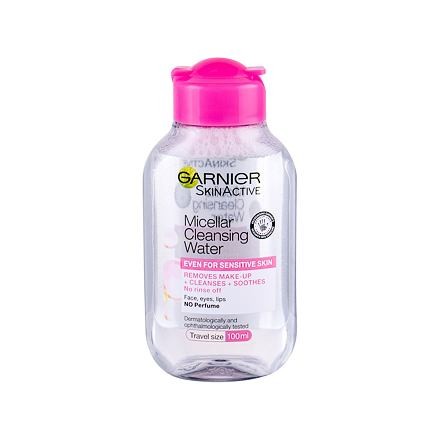 Clear plastic bottle of Garnier Skin Active Micellar Cleansing Water, 100ml, featuring a pink cap and label, designed for sensitive skin, labeled as travel size.