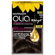 Garnier Olia 3.0 Soft Black hair dye box featuring a bright yellow flower, a golden oil droplet, and text highlighting 100% grey coverage and no ammonia formula.