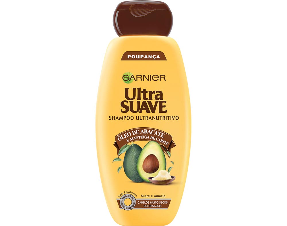 Yellow bottle of Garnier Ultra Suave Shampoo with avocado oil, featuring a brown flip-top lid and an illustration of an avocado on the front, labeled as 600ml.