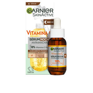 Amber glass bottle with a dropper, labeled "Garnier Skinactive Vitamin C Night Serum," featuring a bright yellow background and a white box with green accents.