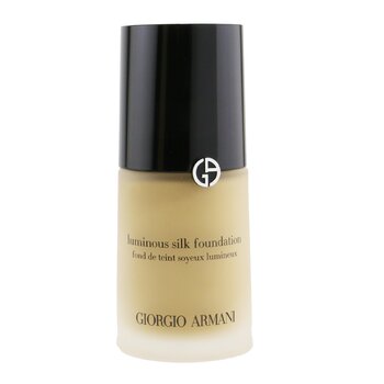 Luminous Silk Foundation in a frosted glass bottle with a black cap, featuring the Giorgio Armani logo, showcasing a light beige liquid inside.